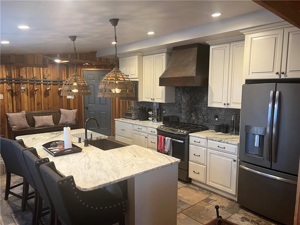 274 Alpine Heights Road Champion, PA 15622 - Photo 8 of 34 a kitchen with a refrigerator a stove a sink dishwasher with a dining table and chairs
