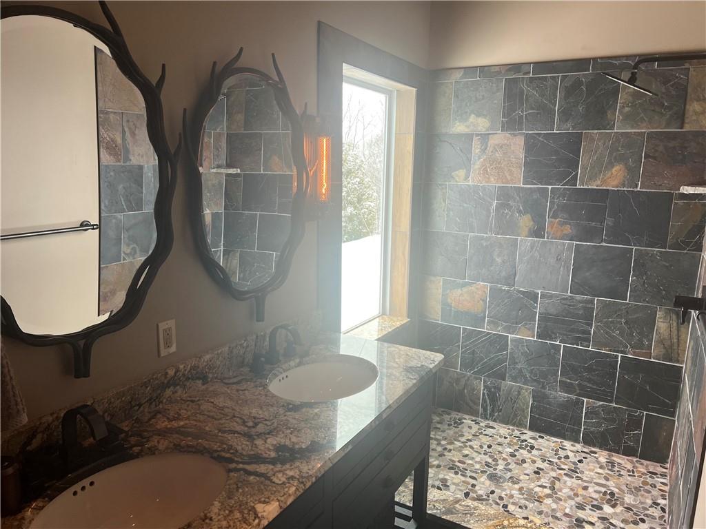 274 Alpine Heights Road Champion, PA 15622 - Photo 10 of 34 a bathroom with a granite countertop sink a mirror and a shower