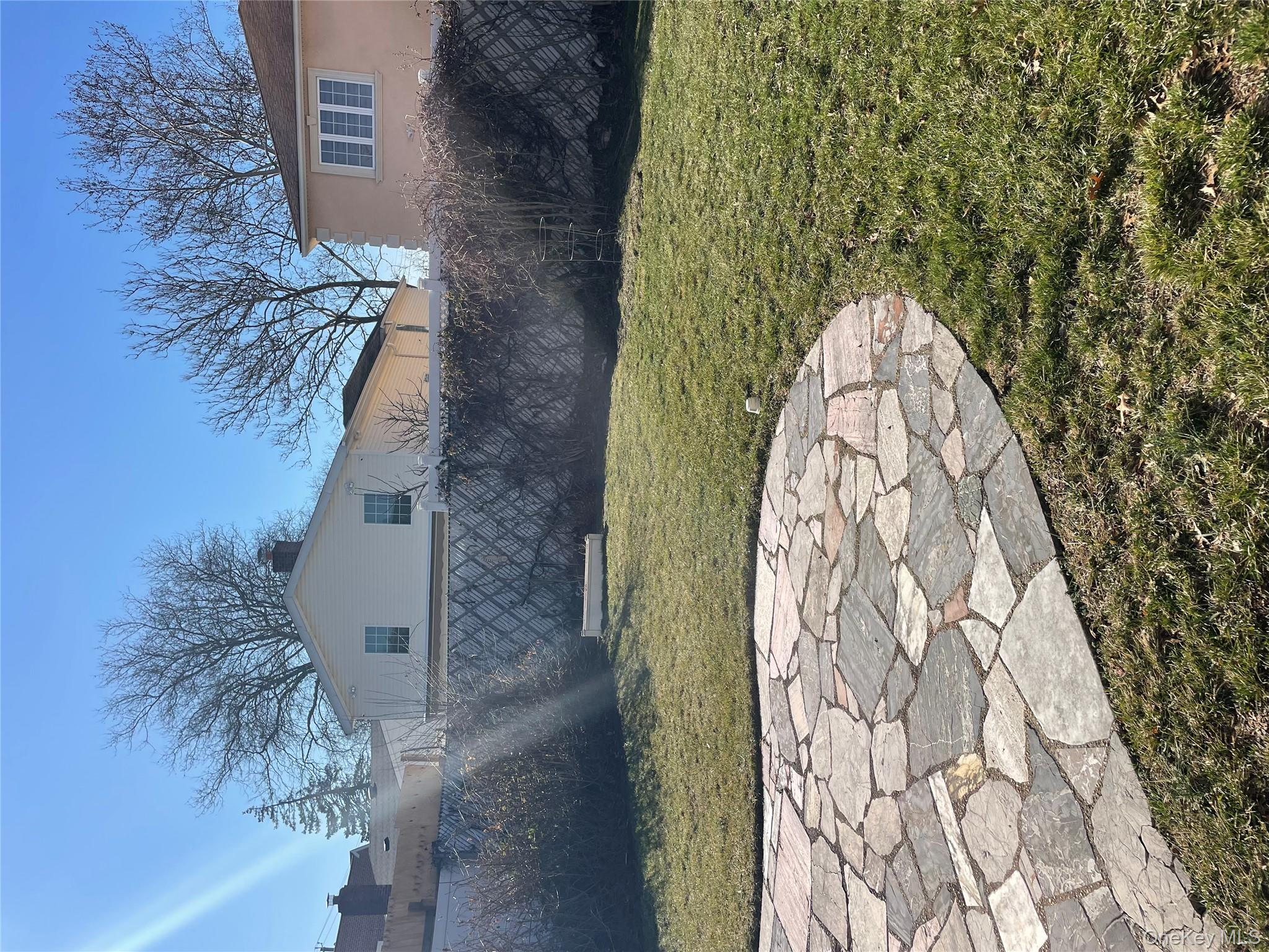 154-58 20th Road Queens, NY 11357 - Photo 21 of 27 a view of a house with a yard