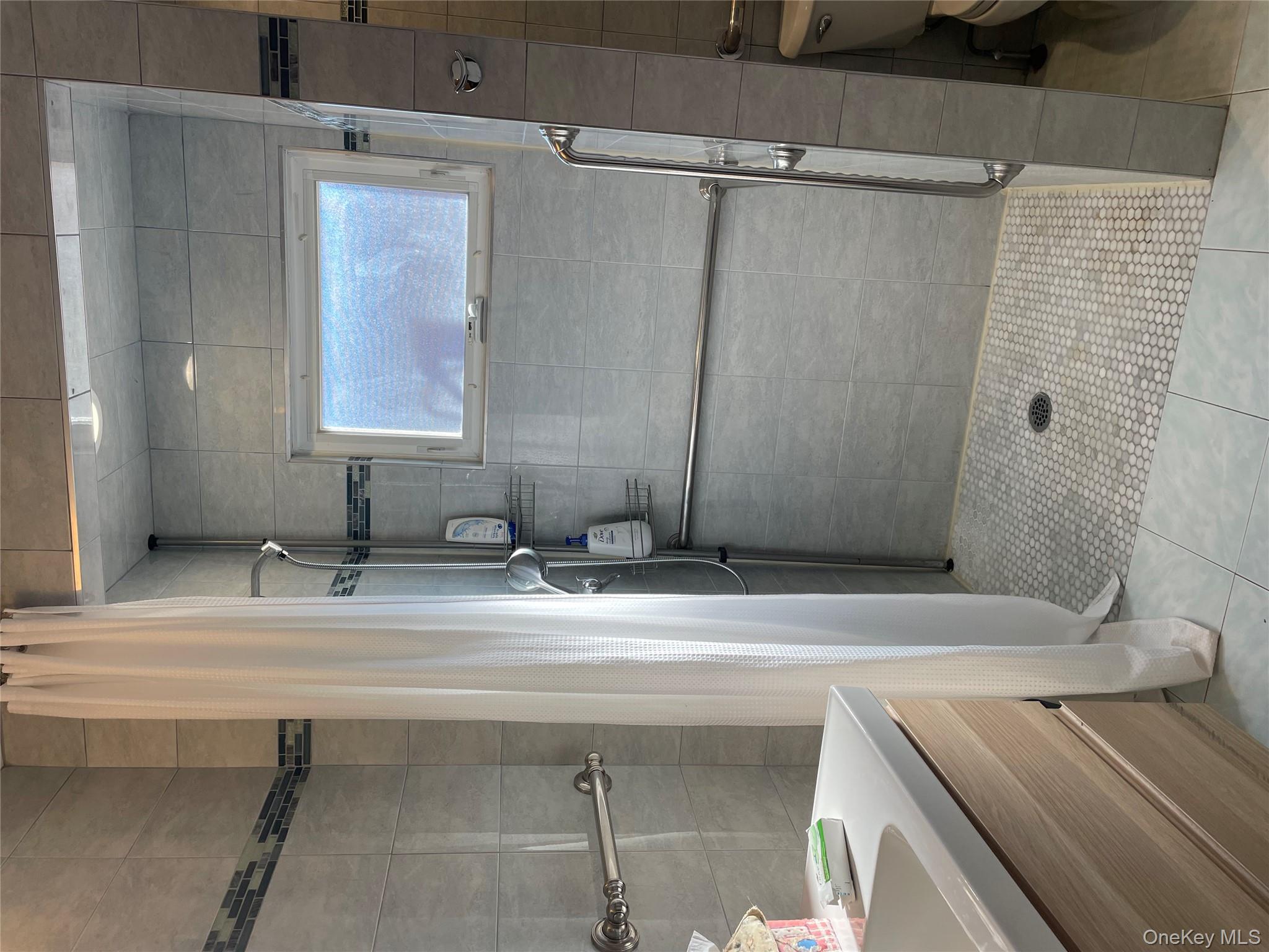 154-58 20th Road Queens, NY 11357 - Photo 10 of 27 a bathroom with a sink and mirror