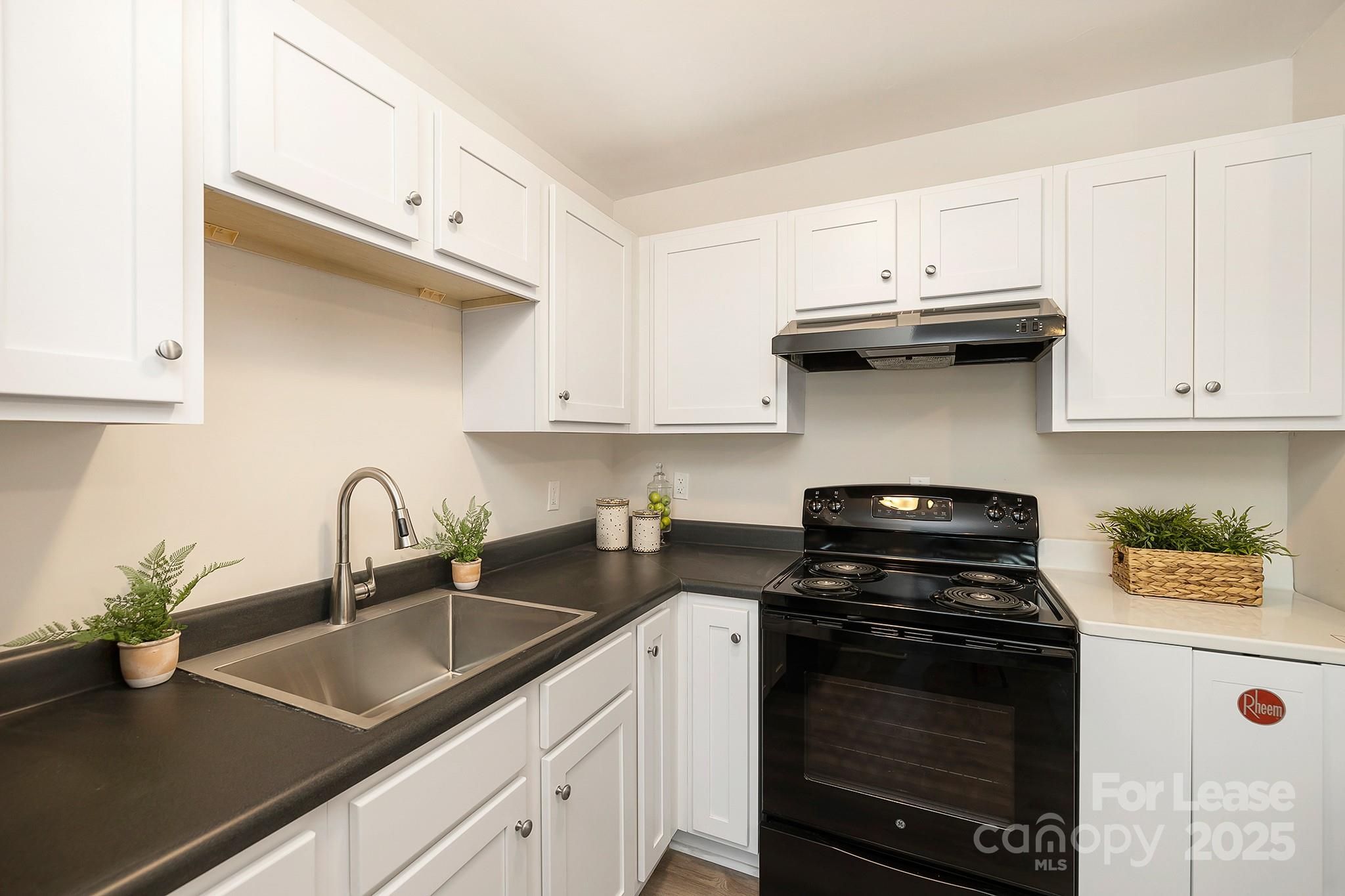 1850 Lowell Bethesda Road, Unit 2 Gastonia, NC 28056 - Photo 7 of 14 a kitchen with stainless steel appliances granite countertop a sink stove and cabinets