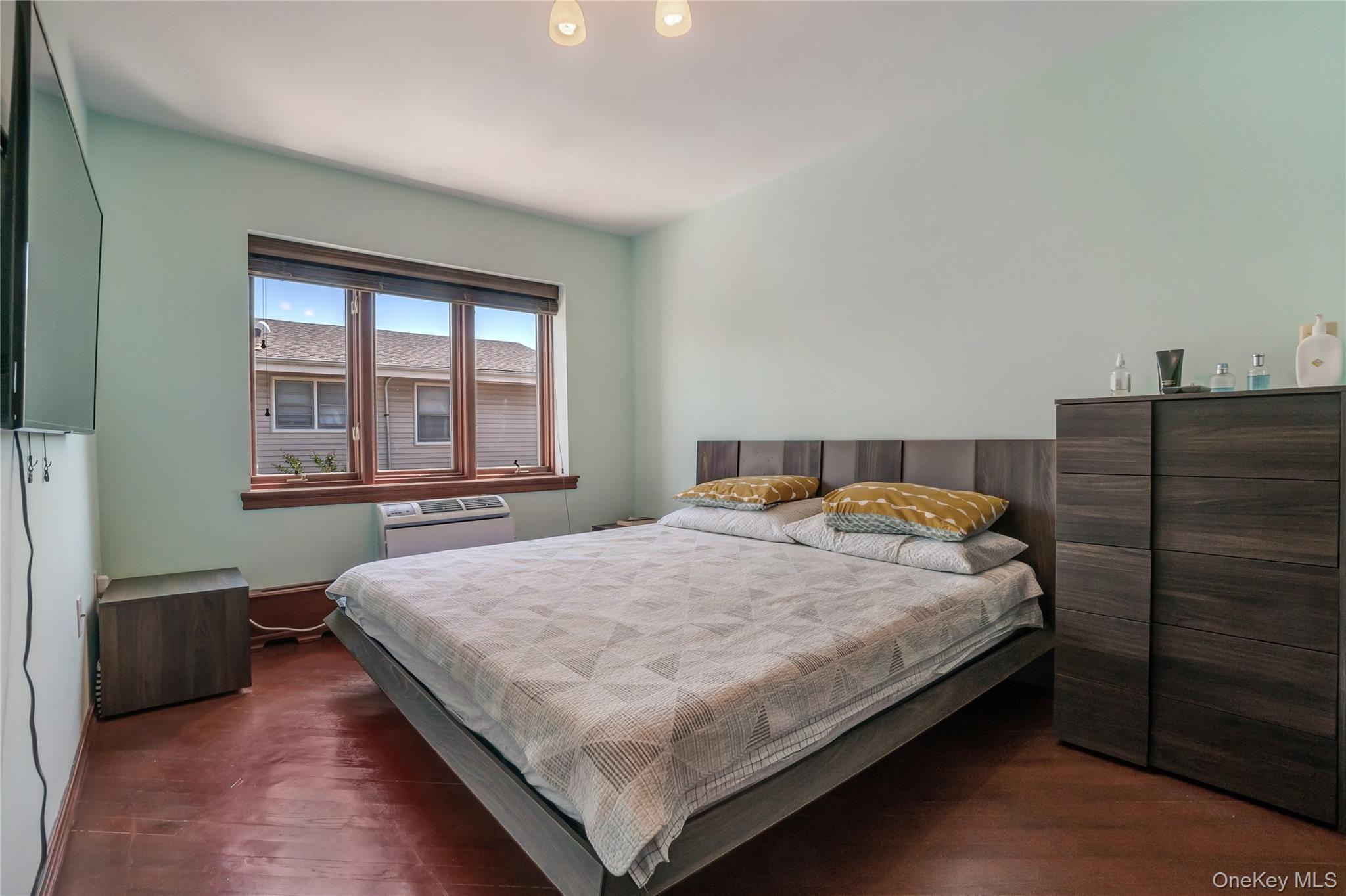 208 Beach 124th Street, Unit 6 Queens, NY 11694 - Photo 12 of 16 a bedroom with a bed and window