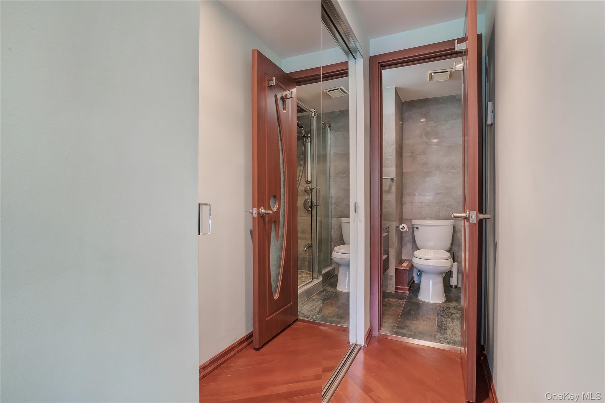 208 Beach 124th Street, Unit 6 Queens, NY 11694 - Photo 13 of 16 a bathroom with a glass shower door