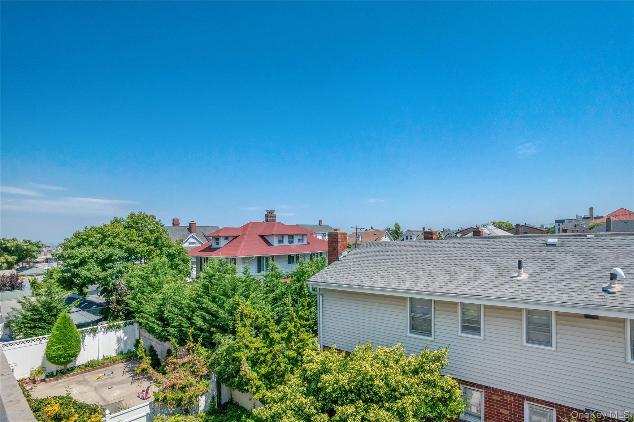 208 Beach 124th Street, Unit 6 Queens, NY 11694 - Photo 15 of 16 a aerial view of a house with a yard and garage