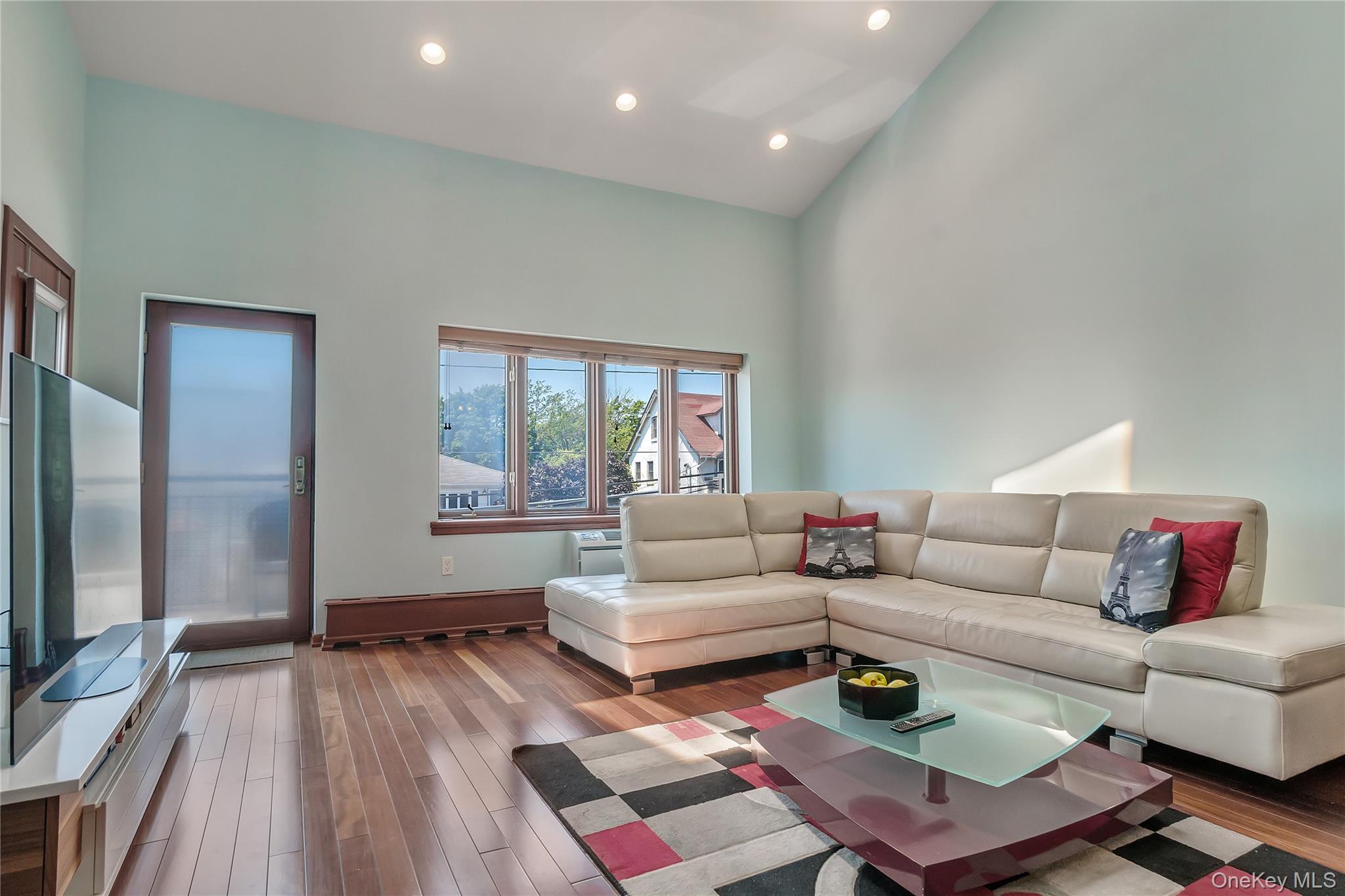 208 Beach 124th Street, Unit 6 Queens, NY 11694 - Photo 5 of 16 a living room with furniture and a large window