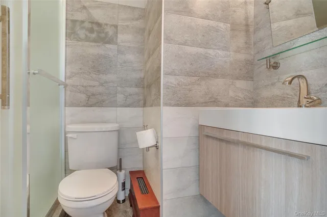 a bathroom with a toilet a sink and shower