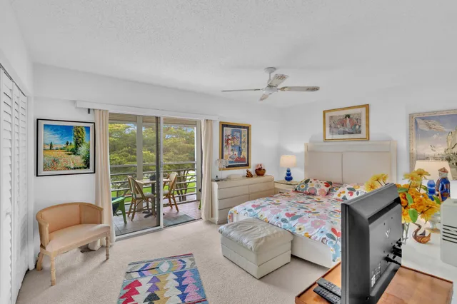 a bedroom that has a bed and a table in it