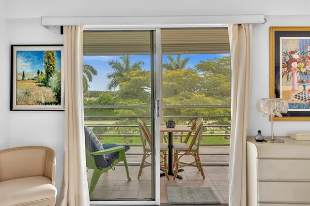 a view of a balcony with a table and chairs