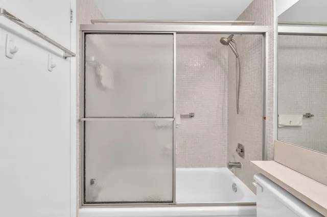 a bathroom with a sink mirror and toilet