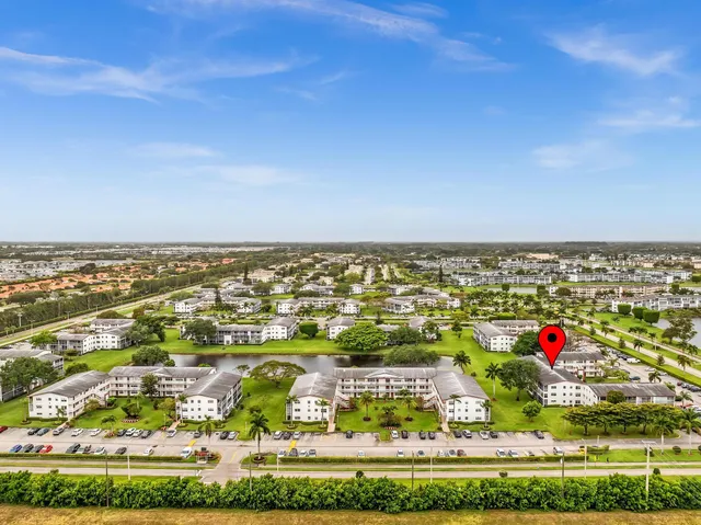 a view of swimming pool with palm trees