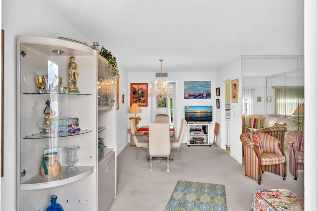 a living room with fireplace furniture and a chandelier