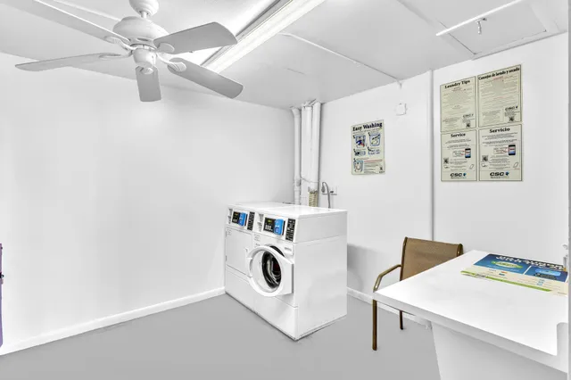 an aerial view of a city with lots of residential buildings ocean and mountain view in back