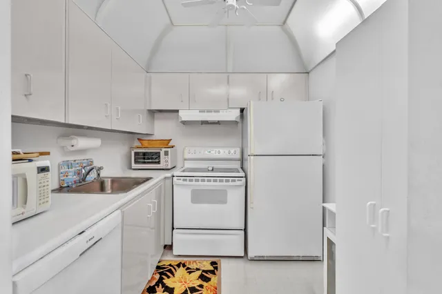 a kitchen with cabinets and a refrigerator