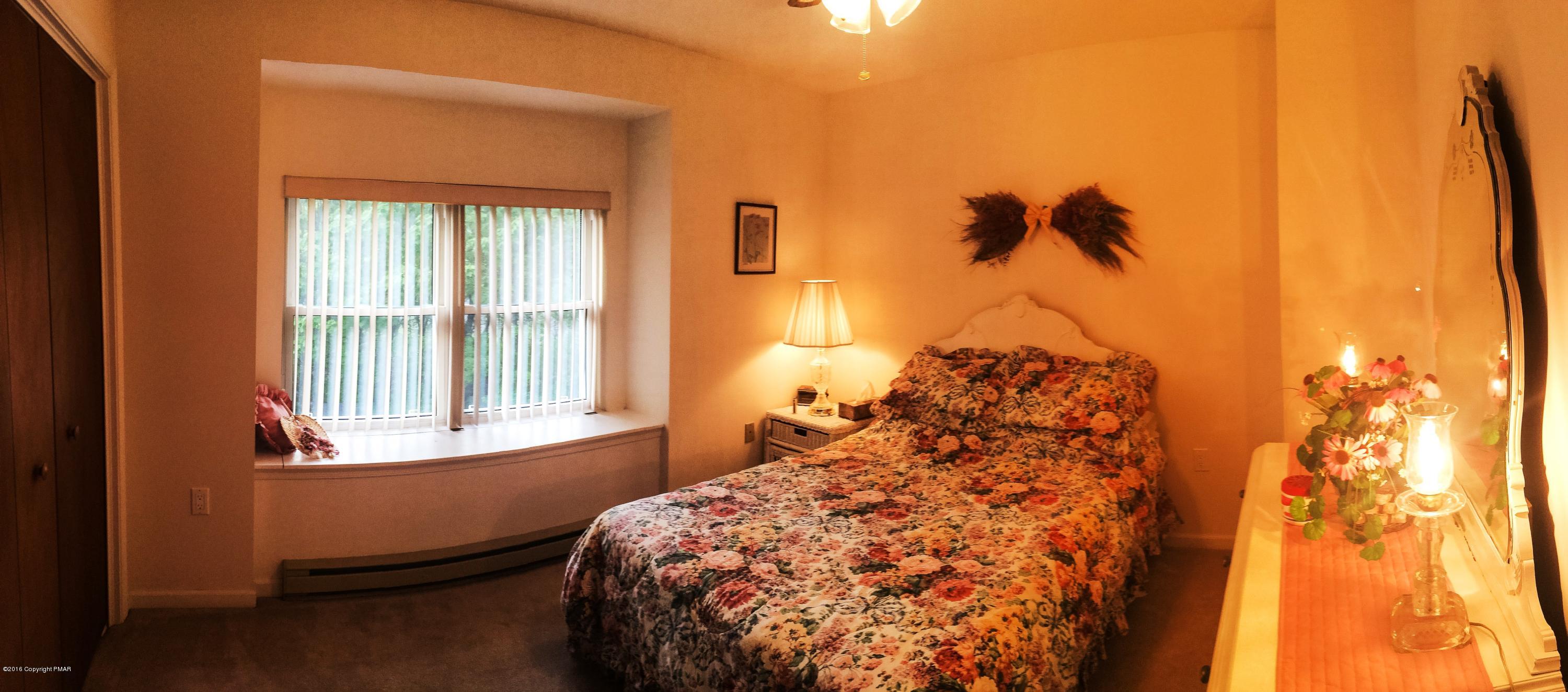 154 Upper Notch Road Albrightsville, PA 18210 - Photo 12 of 25 a bed sitting in a bedroom next to a window