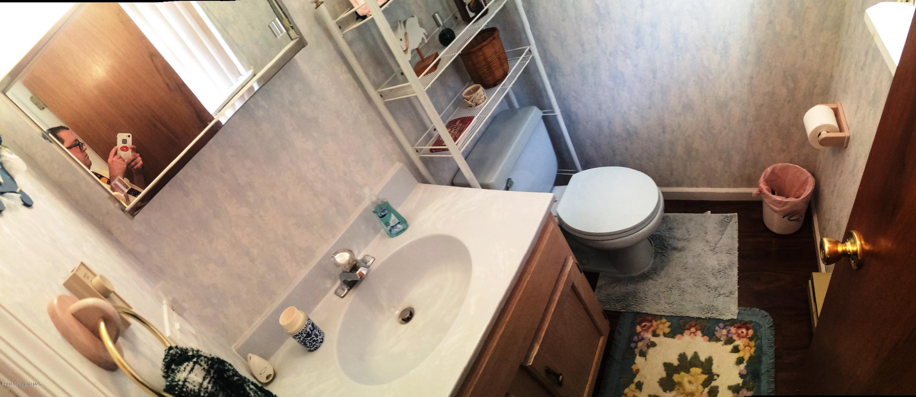 154 Upper Notch Road Albrightsville, PA 18210 - Photo 16 of 25 a bathroom with a sink a toilet and shower curtain