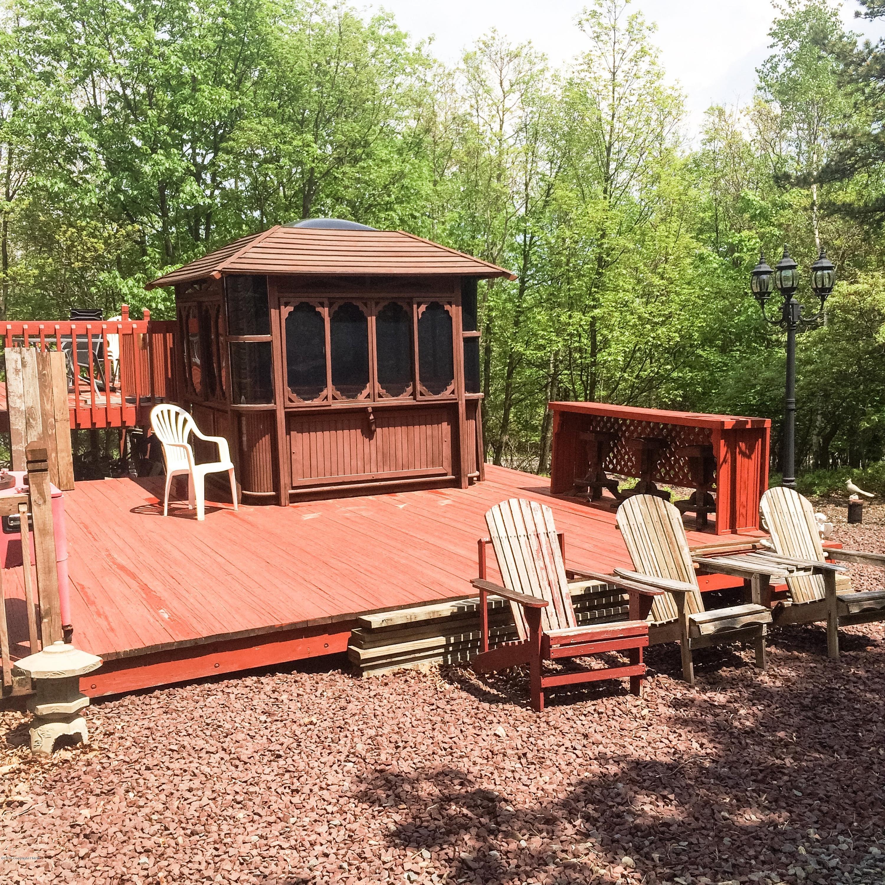 154 Upper Notch Road Albrightsville, PA 18210 - Photo 4 of 25 a view of backyard with a table and chairs under an umbrella