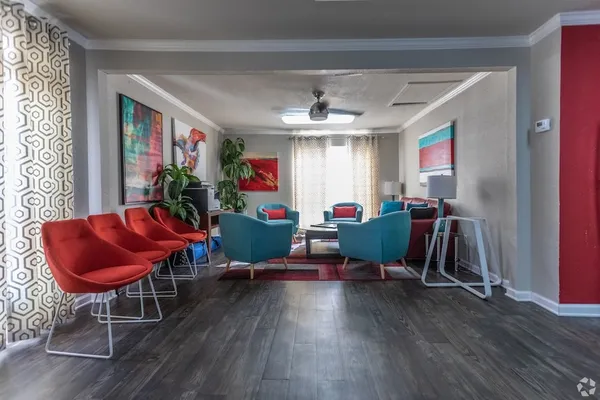 a living room filled with furniture and a wooden floor
