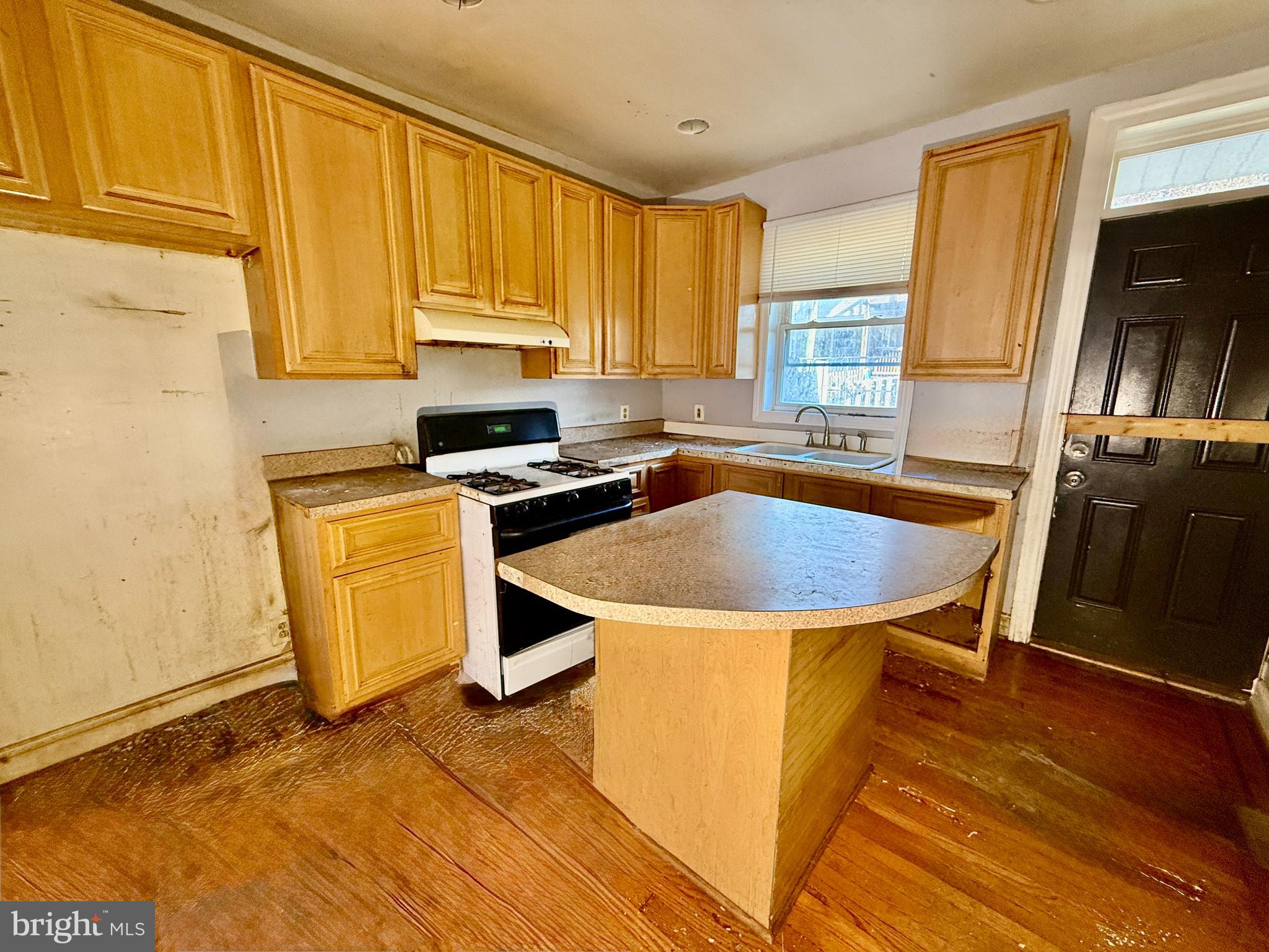 321 South Newkirk Street Baltimore, MD 21224 - Photo 4 of 8 a kitchen with stainless steel appliances granite countertop a sink stove and refrigerator