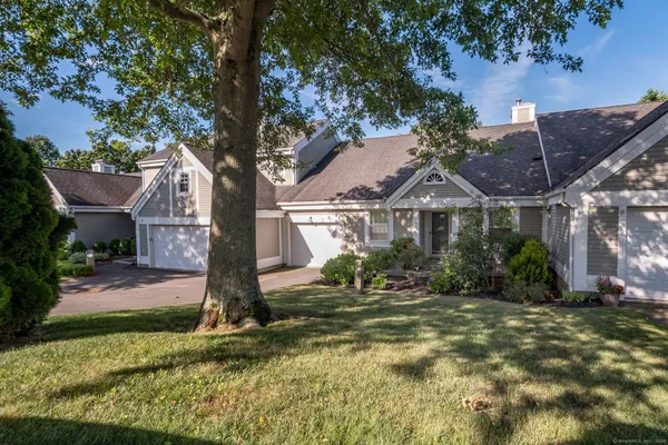 a front view of house with yard and green space