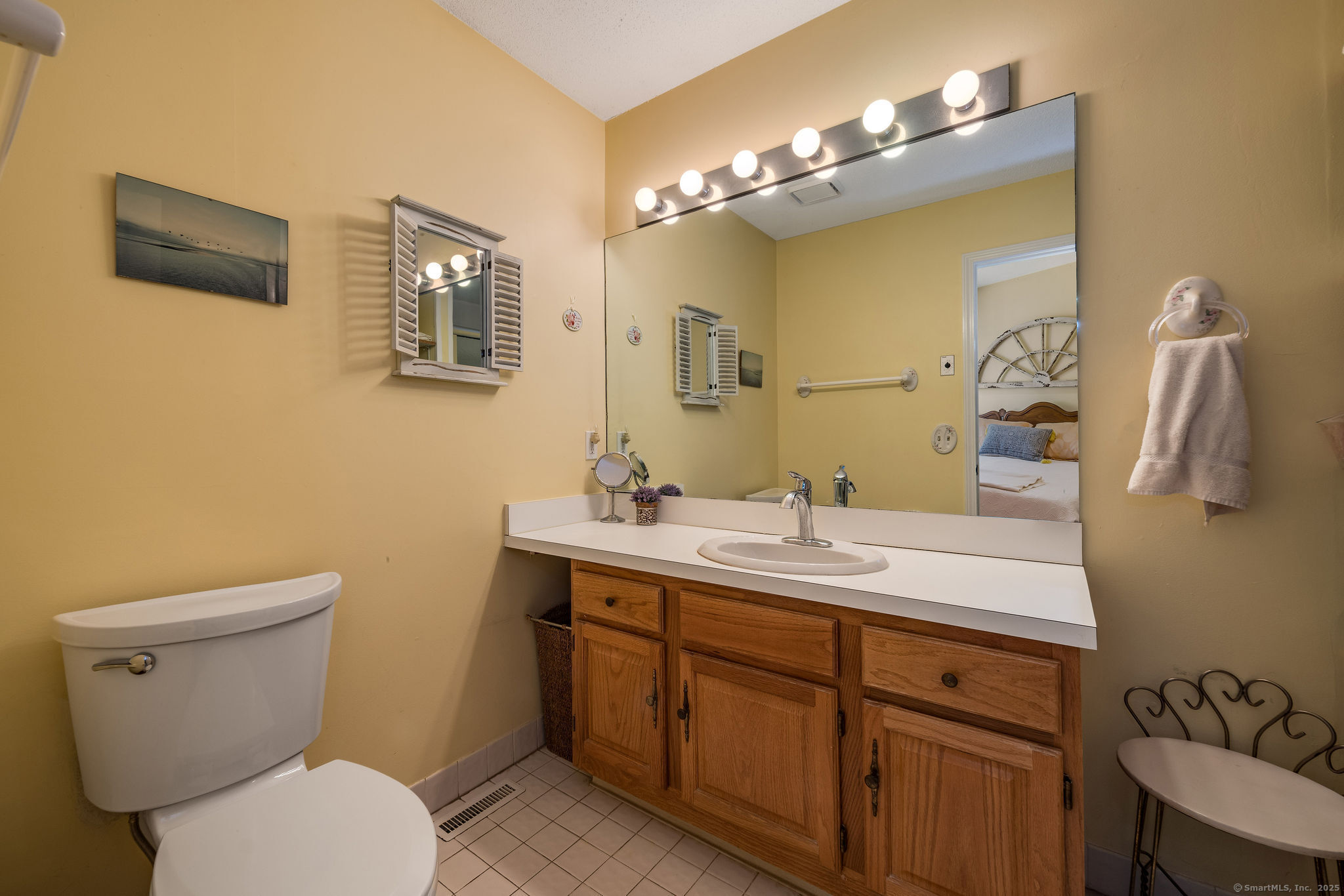 40 Legend Hill Road, Unit 40 Madison, CT 06443 - Photo 17 of 29 a bathroom with a toilet sink and mirror