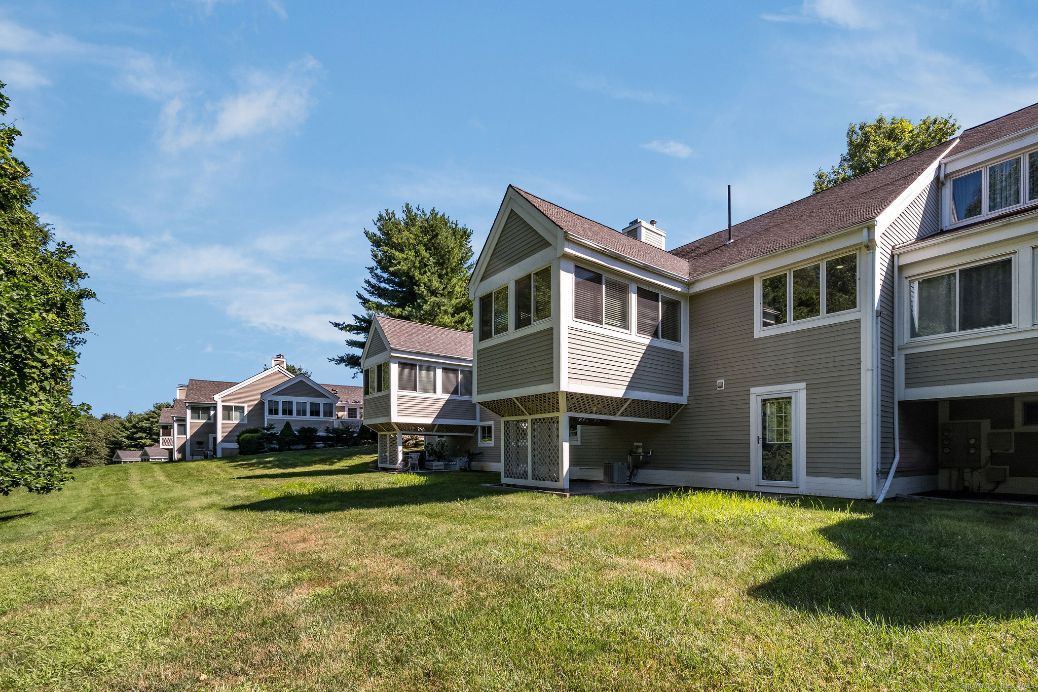40 Legend Hill Road, Unit 40 Madison, CT 06443 - Photo 23 of 29 a front view of a house with a garden and yard