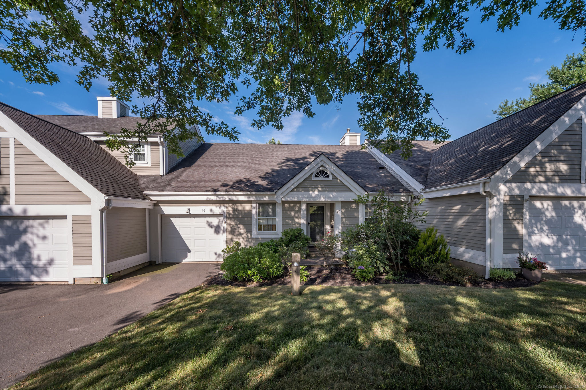 40 Legend Hill Road, Unit 40 Madison, CT 06443 - Photo 4 of 29 front view of a house with a garden
