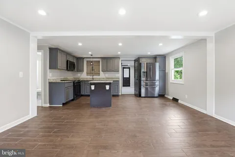 a kitchen with a stove sink and cabinets