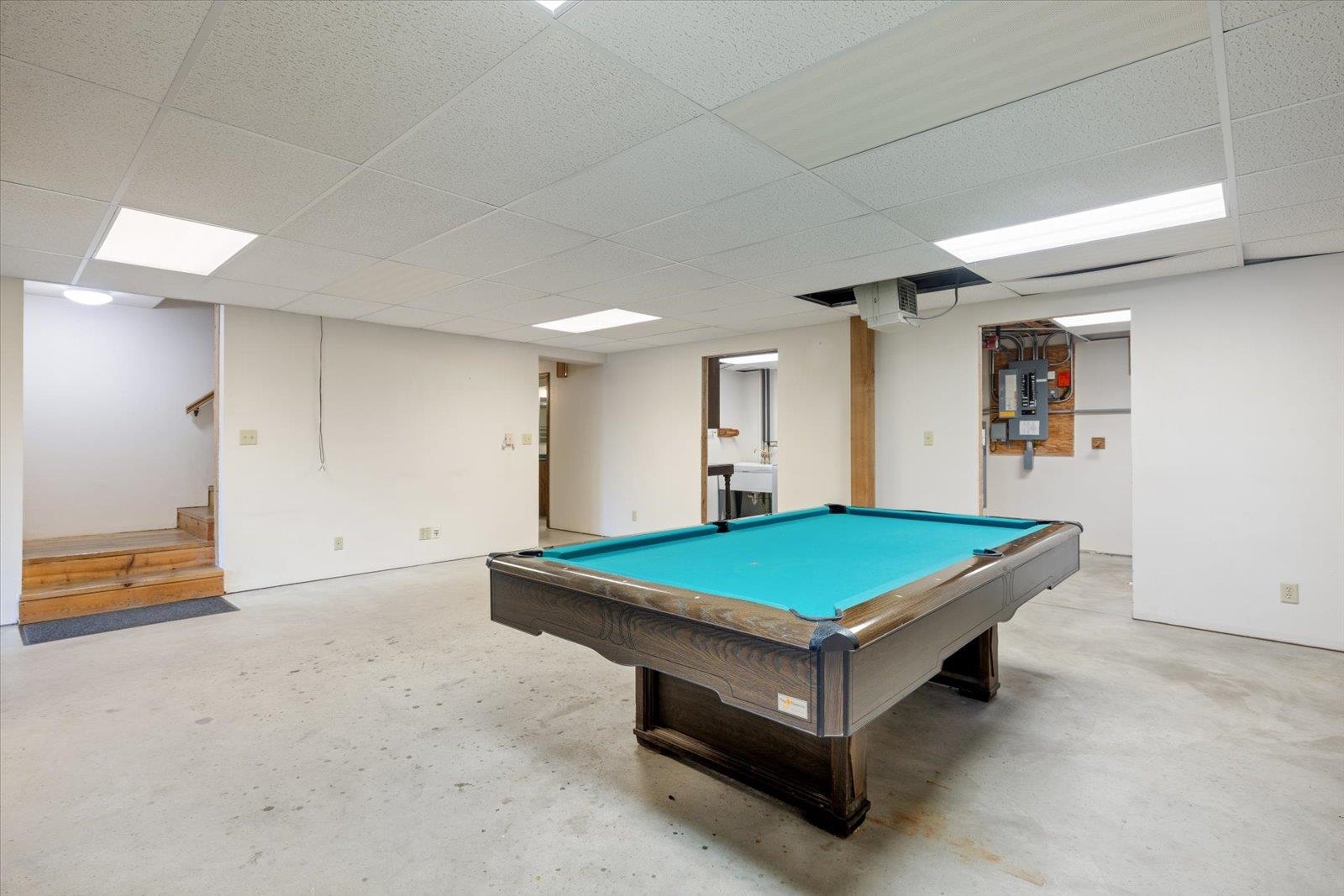 2375 Viste Point Road Ely, MN 55731 - Photo 33 of 83 Family room with pool table, wood stove and walk out with views of Burntside Lake