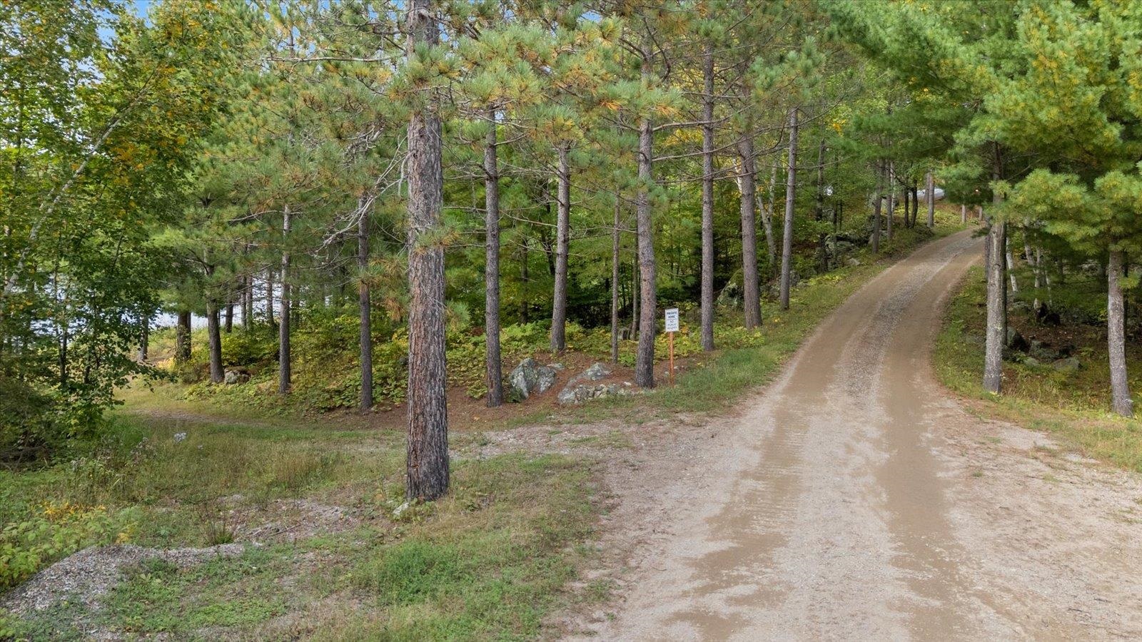 2375 Viste Point Road Ely, MN 55731 - Photo 53 of 83 View of road with driveway to first dock to the left and detached one of the detaches garages to the right
