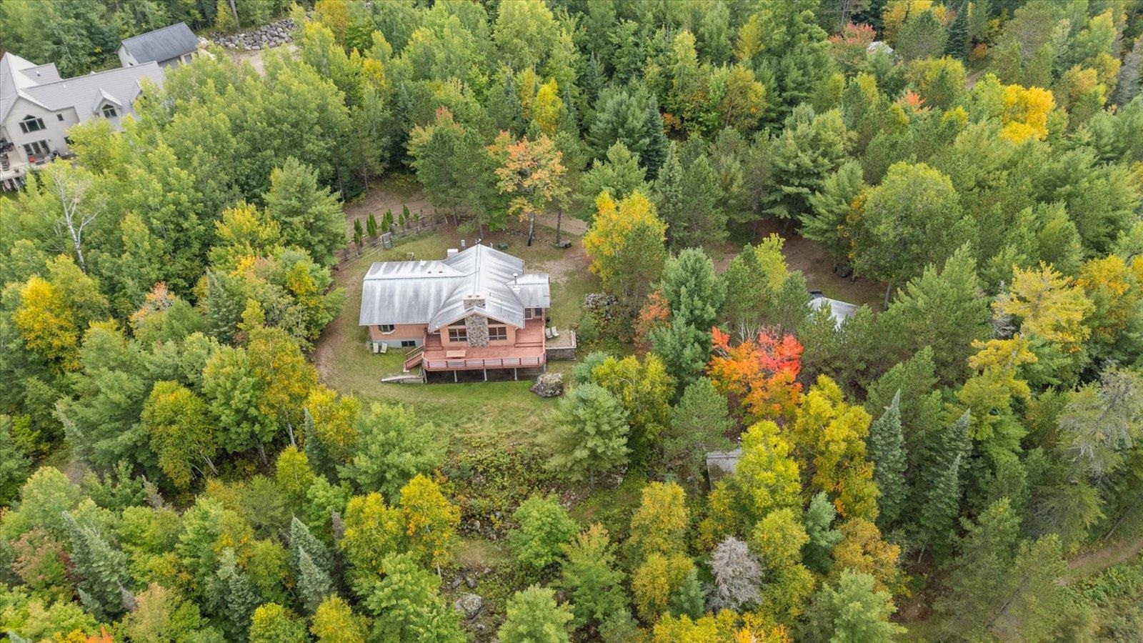 2375 Viste Point Road Ely, MN 55731 - Photo 10 of 83 Aerial view of property and surrounding area featuring a heavily wooded area