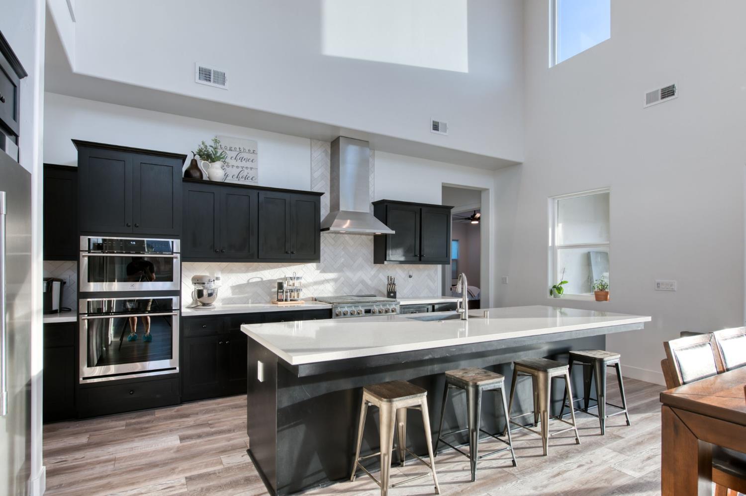 1736 North Renn Avenue Clovis, CA 93619 - Photo 11 of 66 a kitchen with stainless steel appliances granite countertop a sink and stove