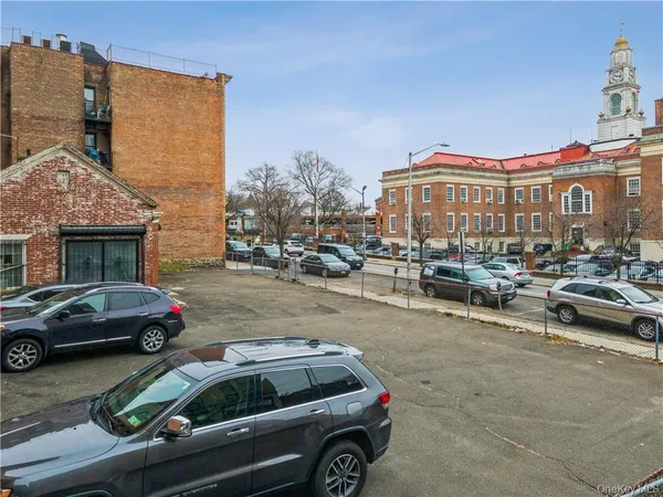 a view of a cars park in front of a building