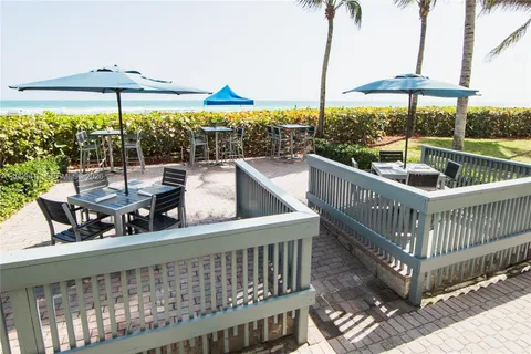 a view of a roof deck with furniture