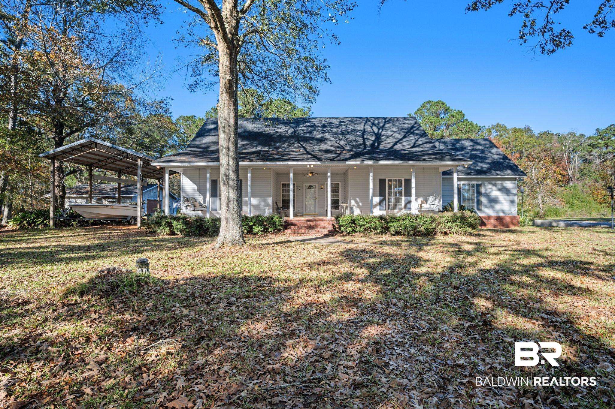 15801 Maytower Road Bay Minette, AL 36507 - Photo 1 of 43 View of front of house featuring a carport, a porch, and a front lawn
