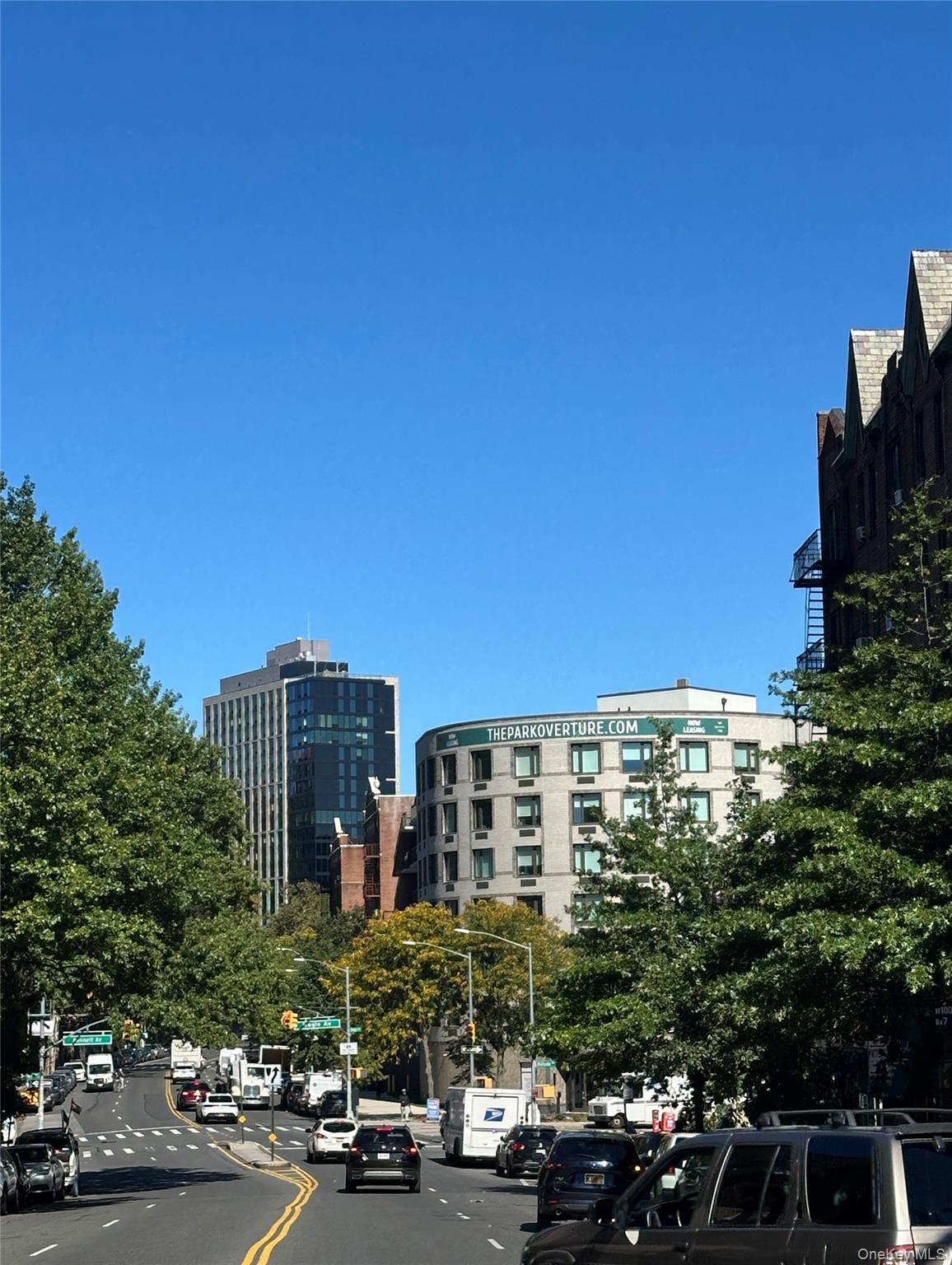 a view of a building with cars parked