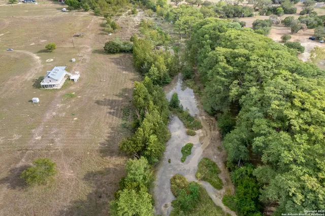 an aerial view of a houses with yard