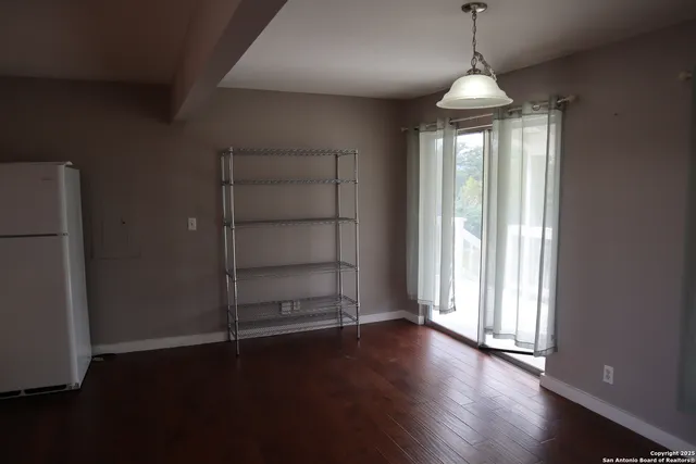 a view of wooden floor and windows in a room