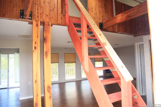 a view of front door with wooden floor and stairs