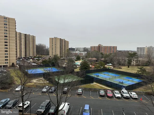 a living room with lots of furniture and view of kitchen