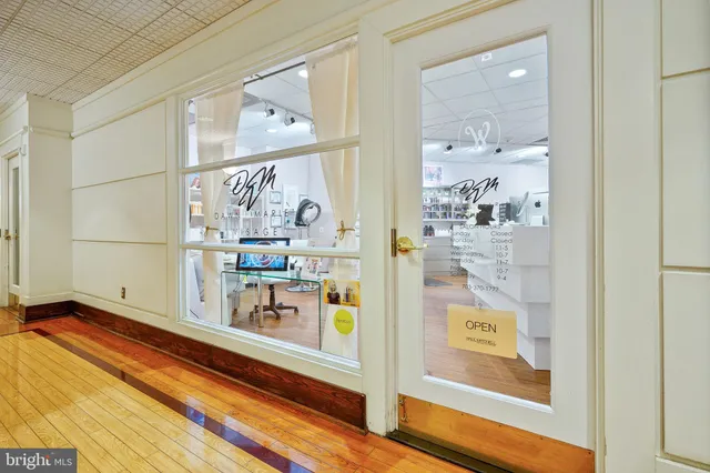 a reading room with furniture book shelf and rug