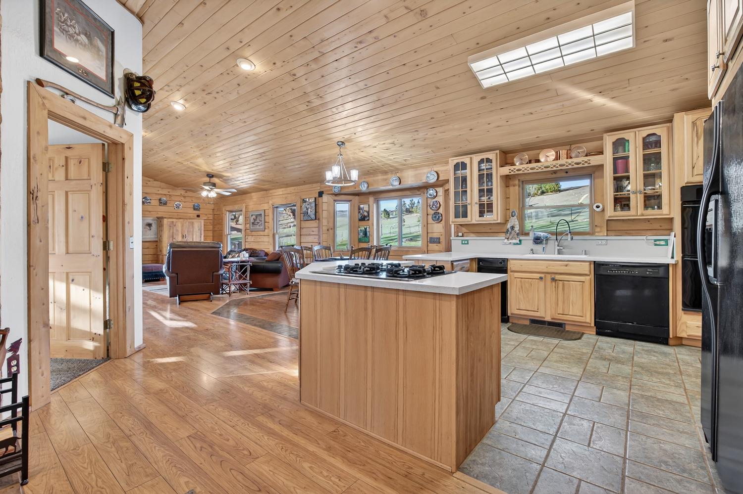 10394 Ponderosa Way Mountain Ranch, CA 95246 - Photo 13 of 58 a kitchen with stainless steel appliances granite countertop a stove top oven a refrigerator a sink and dishwasher