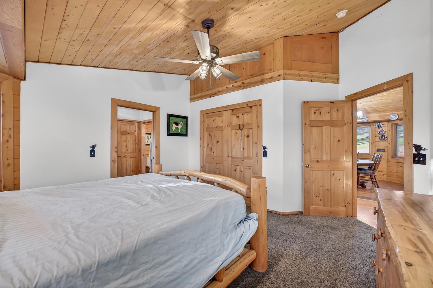 10394 Ponderosa Way Mountain Ranch, CA 95246 - Photo 19 of 58 a spacious bedroom with a bed and a walk in closet