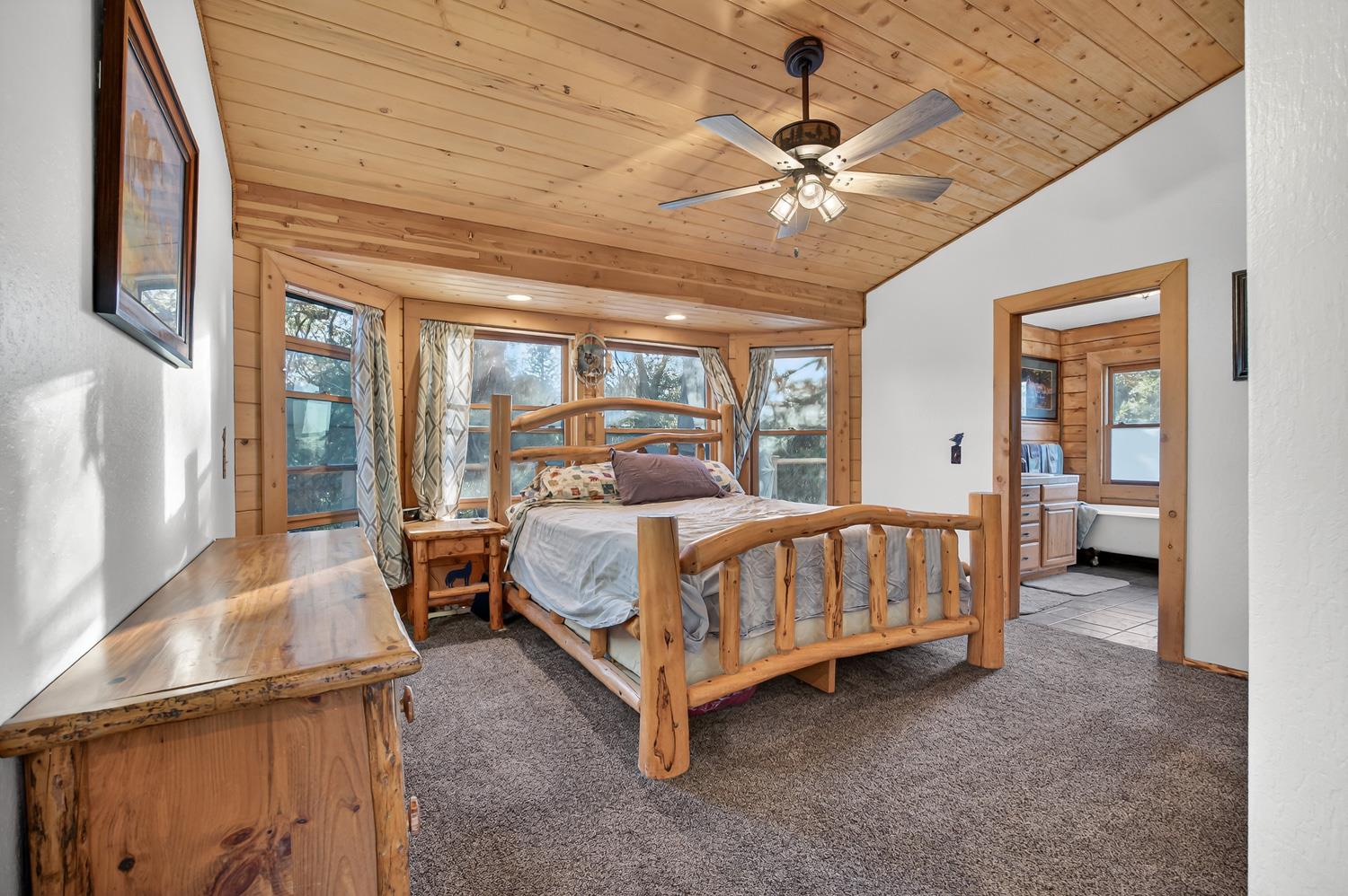 10394 Ponderosa Way Mountain Ranch, CA 95246 - Photo 20 of 58 a bed room with a bed and a chandelier