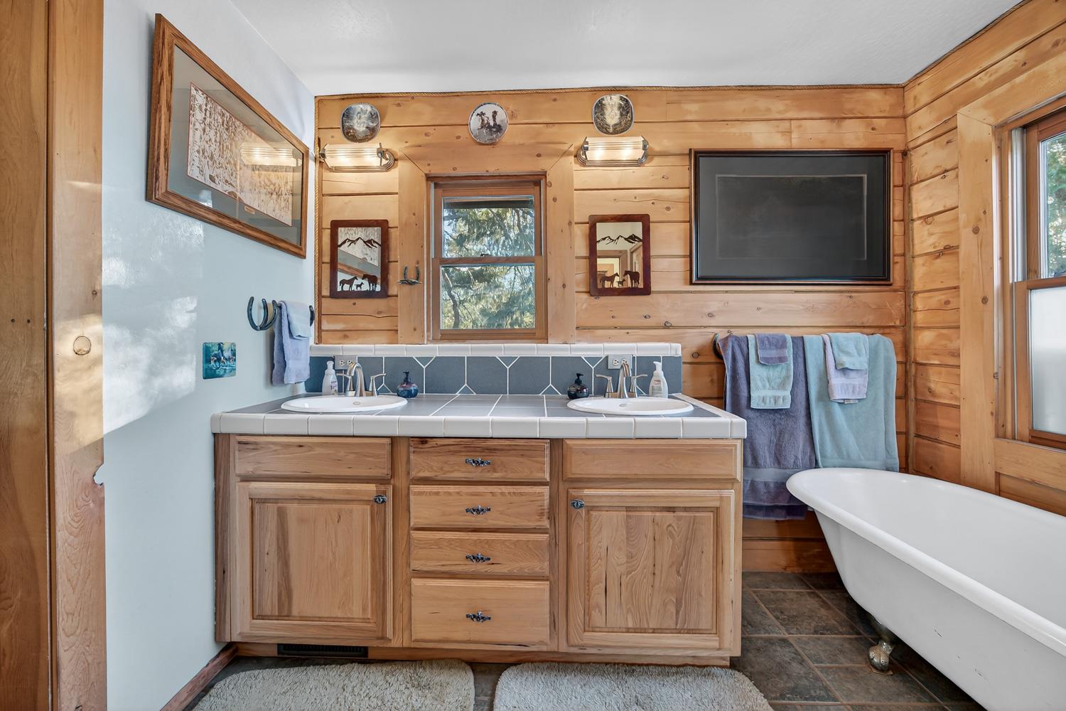 10394 Ponderosa Way Mountain Ranch, CA 95246 - Photo 21 of 58 a bathroom with a sink a mirror a bathtub and a toilet