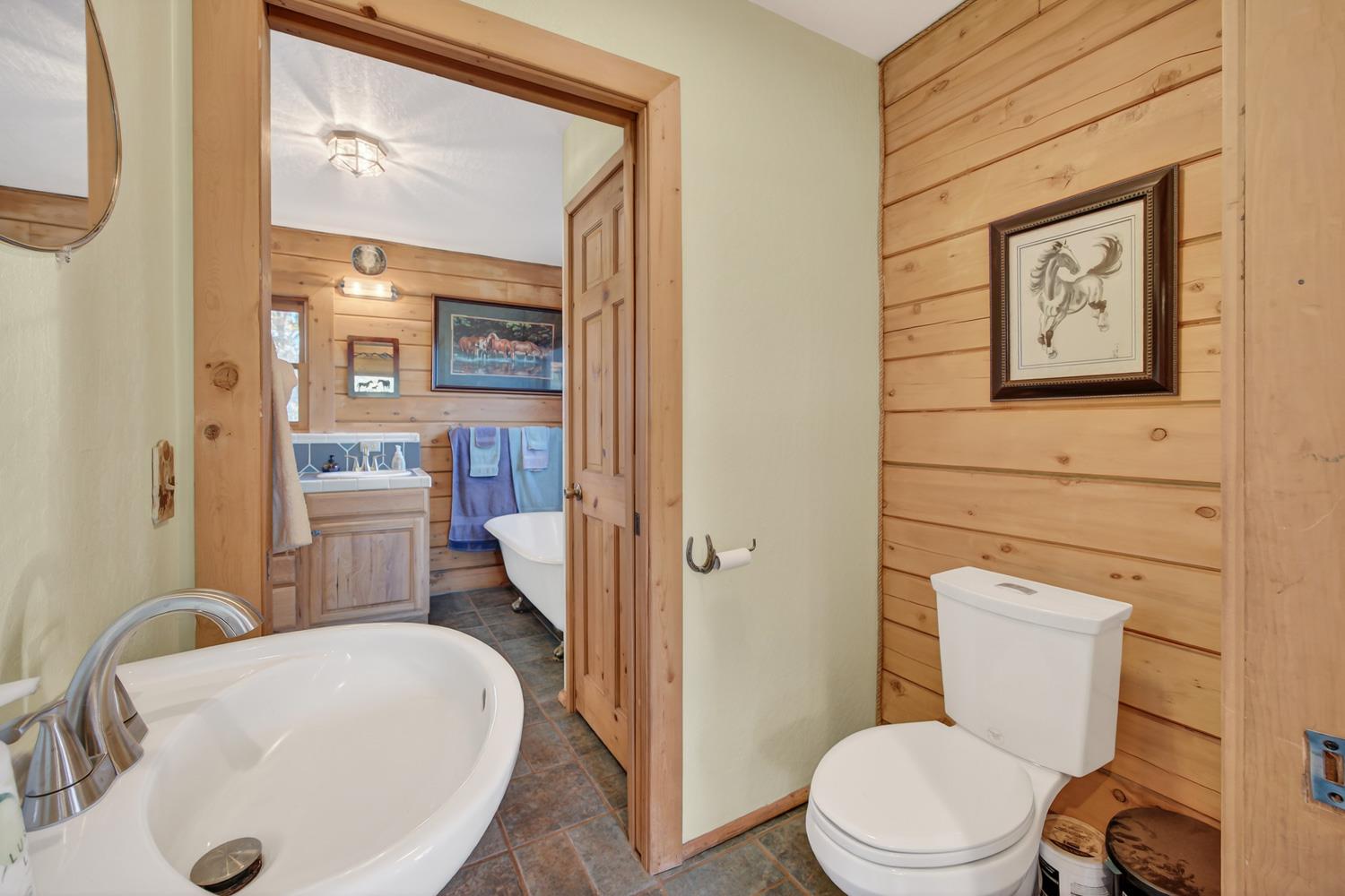 10394 Ponderosa Way Mountain Ranch, CA 95246 - Photo 25 of 58 a white toilet sitting next to a bathroom sink
