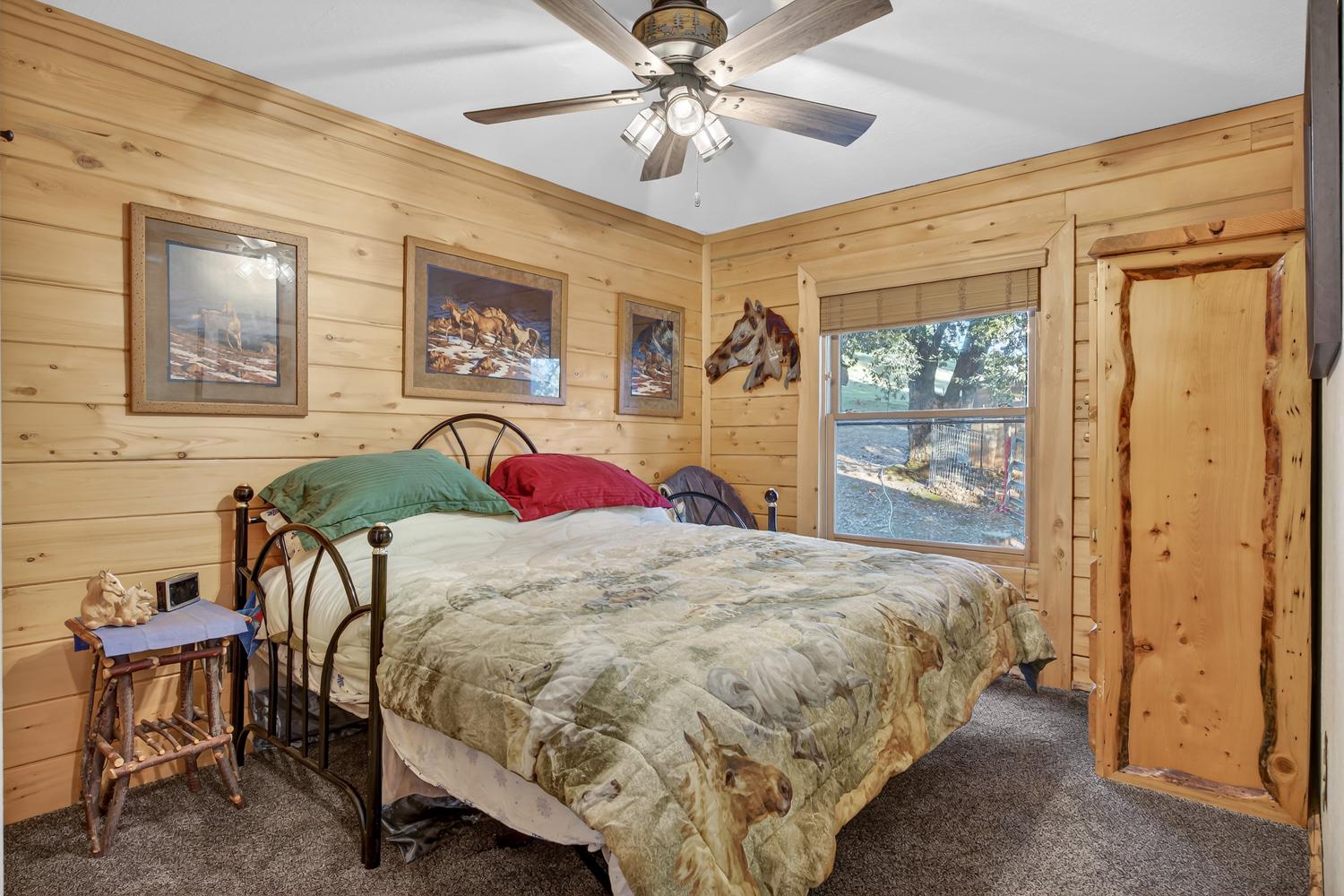 10394 Ponderosa Way Mountain Ranch, CA 95246 - Photo 30 of 58 a bed sitting in a bedroom next to a window