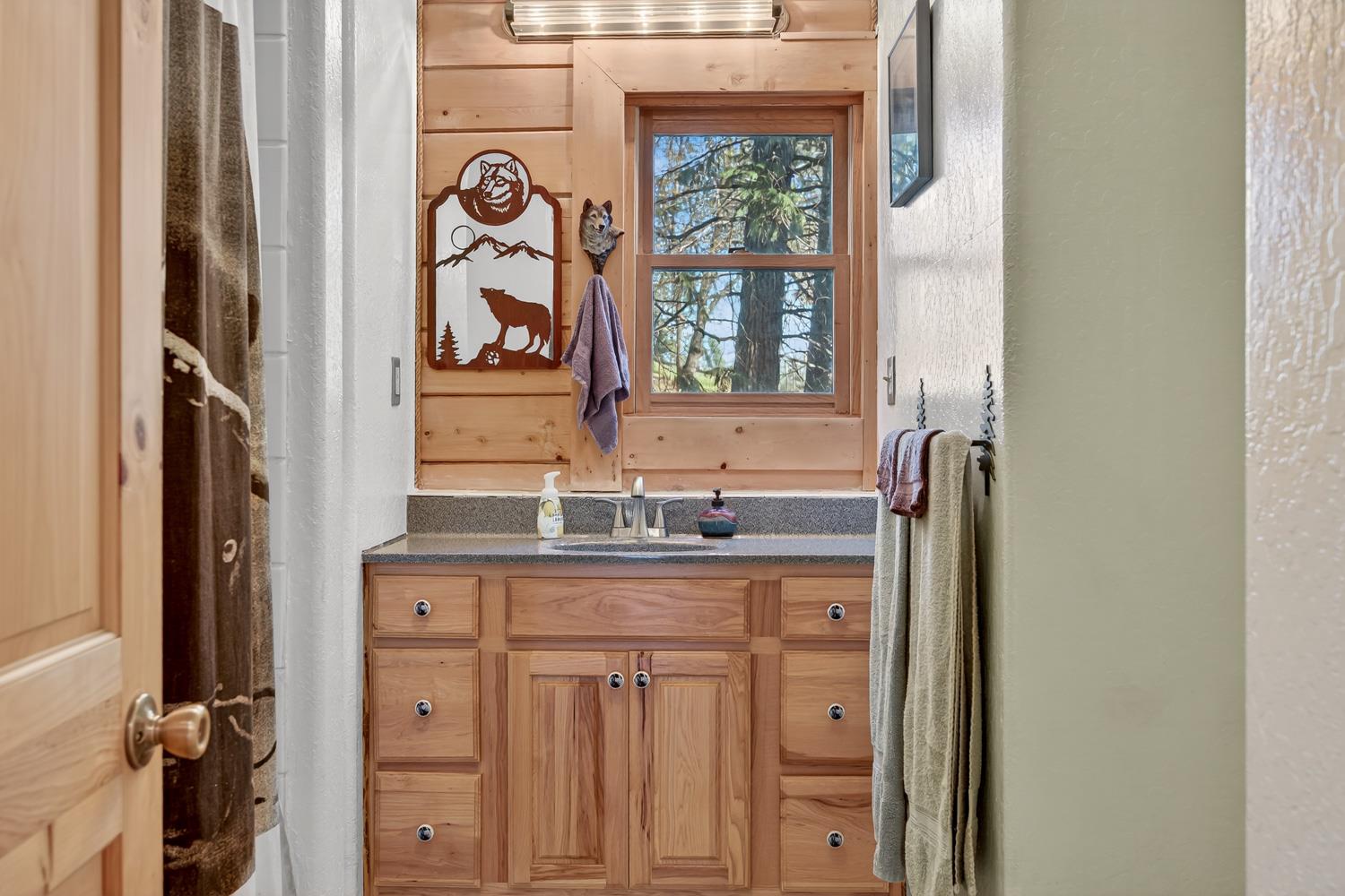 10394 Ponderosa Way Mountain Ranch, CA 95246 - Photo 32 of 58 a bathroom with a granite countertop sink and a window