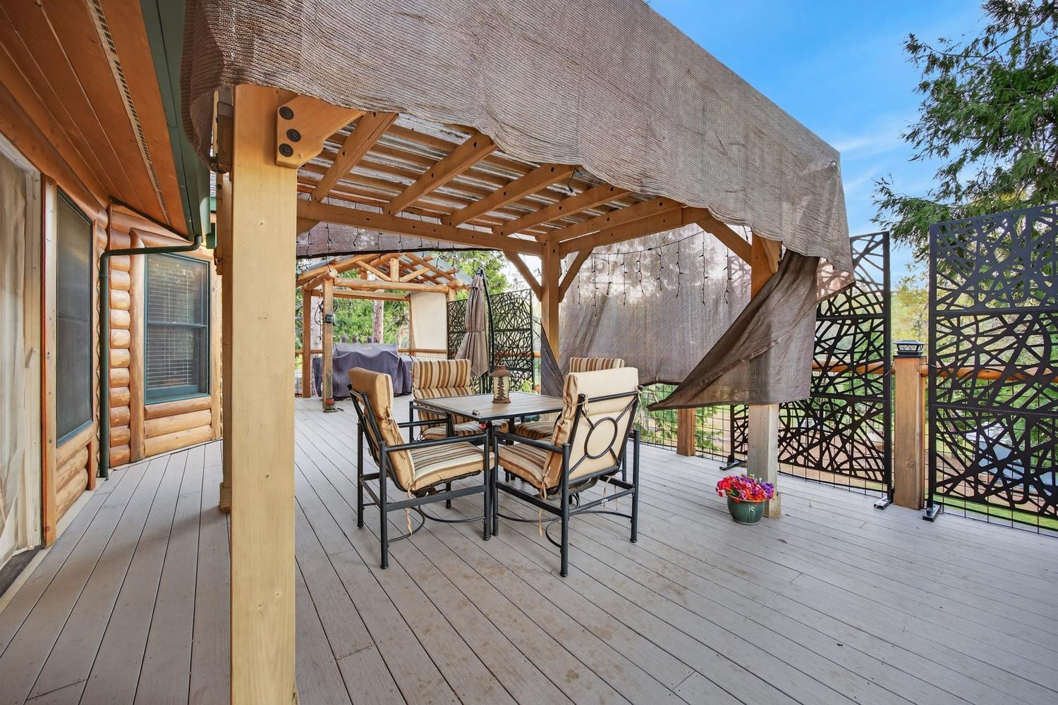 10394 Ponderosa Way Mountain Ranch, CA 95246 - Photo 35 of 58 a view of a dinning room with wooden floor and outdoor seating