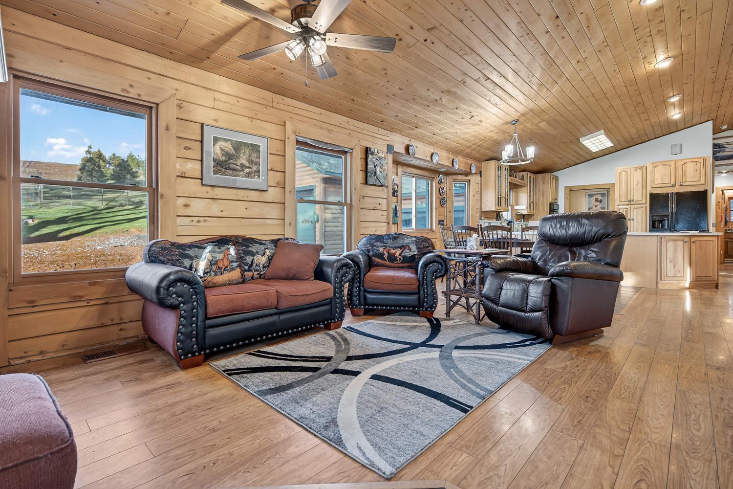 10394 Ponderosa Way Mountain Ranch, CA 95246 - Photo 5 of 58 a living room with furniture and a floor to ceiling window