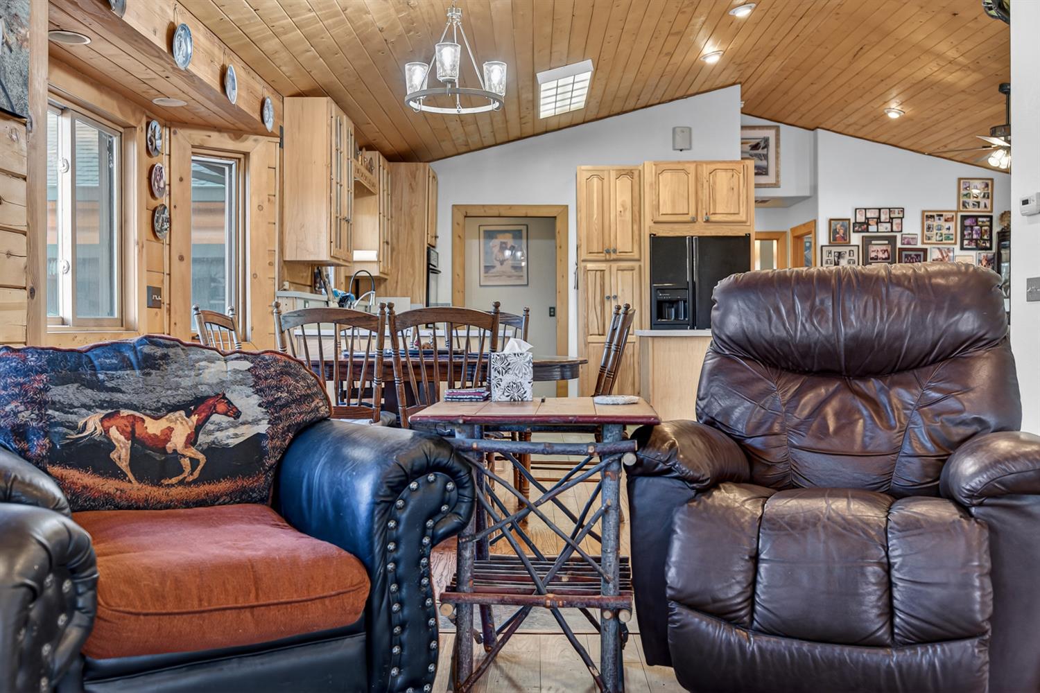 10394 Ponderosa Way Mountain Ranch, CA 95246 - Photo 7 of 58 a living room with furniture a fireplace and a chandelier
